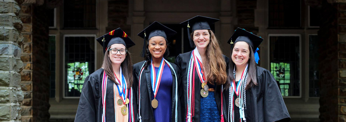 Cabrini students in caps and gowns with award medallions